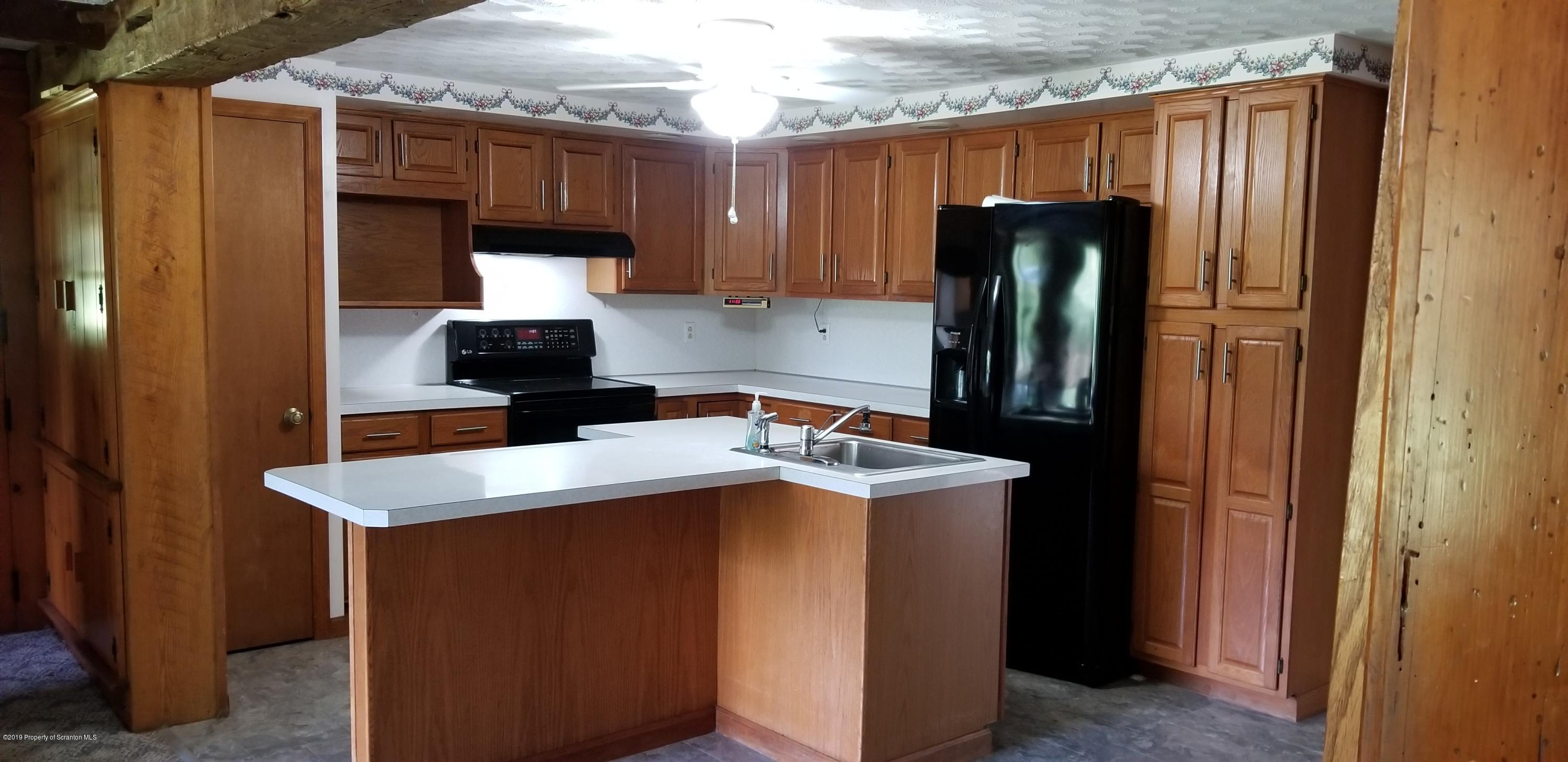 252 School House Road Tunkhannock, PA 18657 - Photo 8 of 20 a kitchen with a sink and a refrigerator
