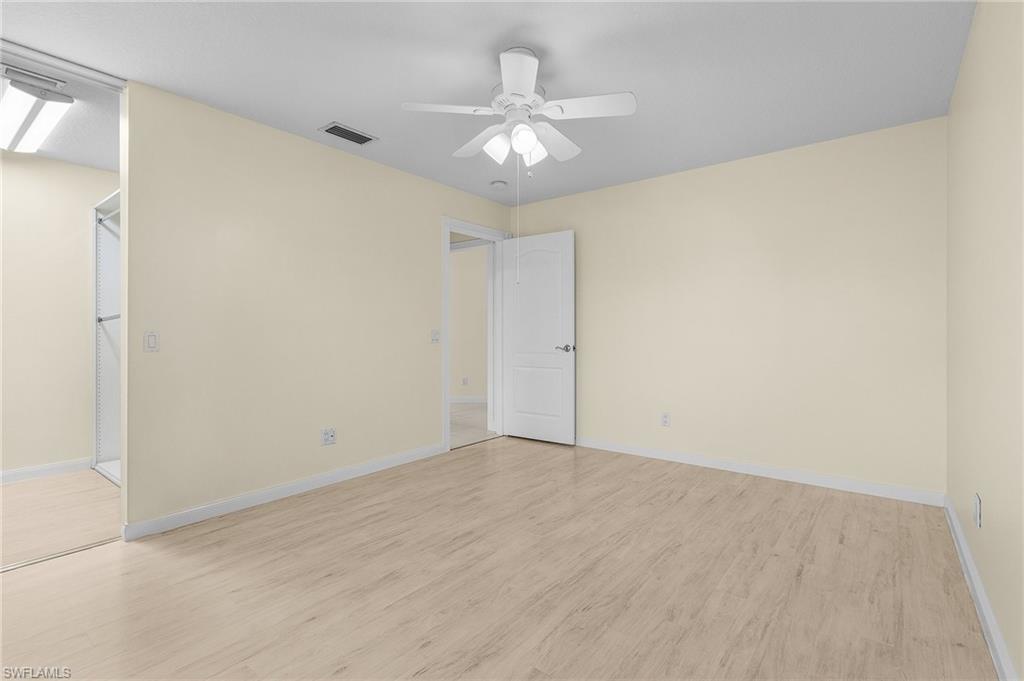 4187 St George Lane Naples, FL 34119 - Photo 14 of 27 Unfurnished room featuring light wood-type flooring and ceiling fan