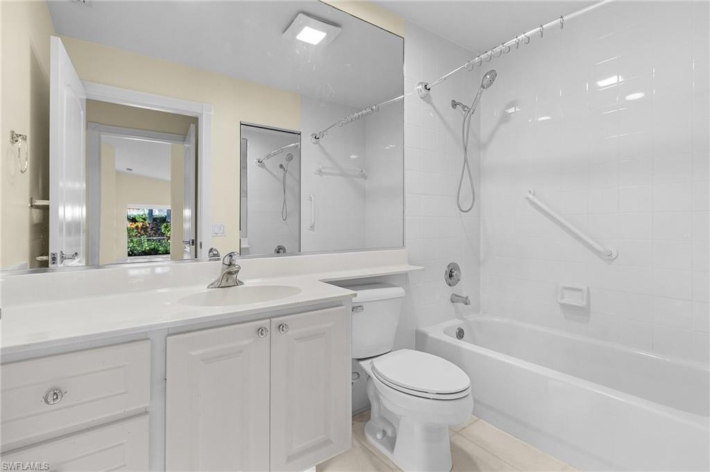 4187 St George Lane Naples, FL 34119 - Photo 15 of 27 Full bathroom with vanity, tile patterned flooring, tiled shower / bath, and toilet