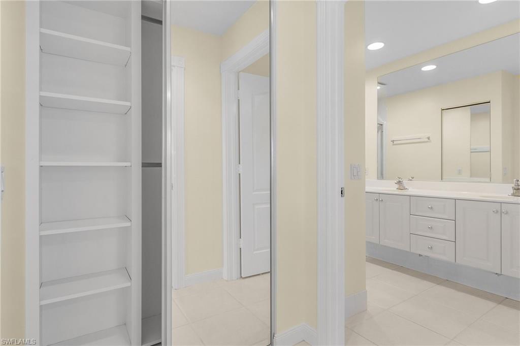 4187 St George Lane Naples, FL 34119 - Photo 18 of 27 Bathroom with tile patterned floors and vanity