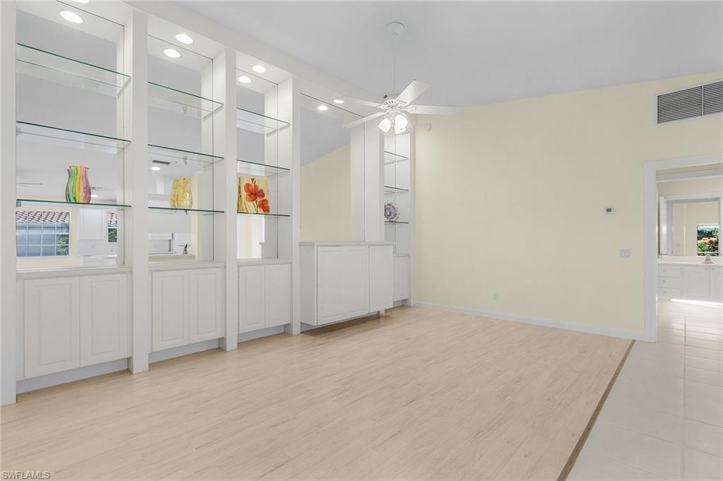 4187 St George Lane Naples, FL 34119 - Photo 10 of 27 Unfurnished room featuring ceiling fan, plenty of natural light, and light hardwood / wood-style flooring