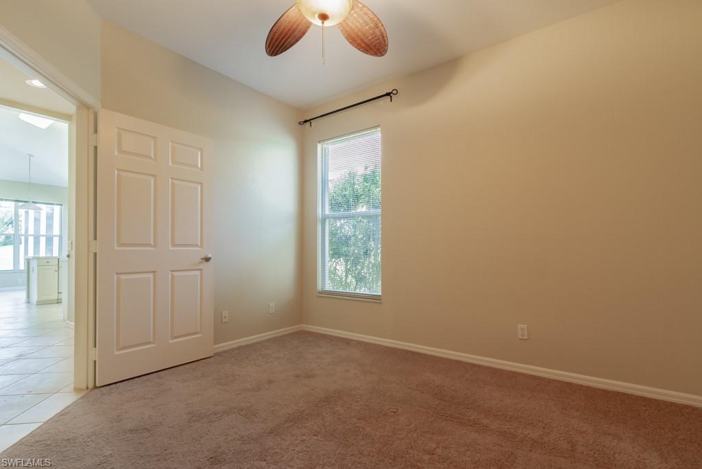 1869 Pondside Lane Naples, FL 34109 - Photo 15 of 35 an empty room with windows and fan