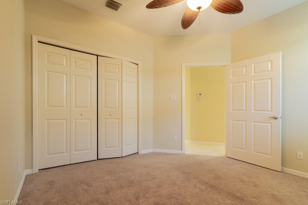 1869 Pondside Lane Naples, FL 34109 - Photo 16 of 35 an empty room with closet area