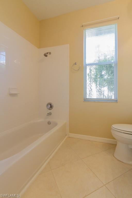 1869 Pondside Lane Naples, FL 34109 - Photo 17 of 35 a bath room with a toilet a bath tub and a window