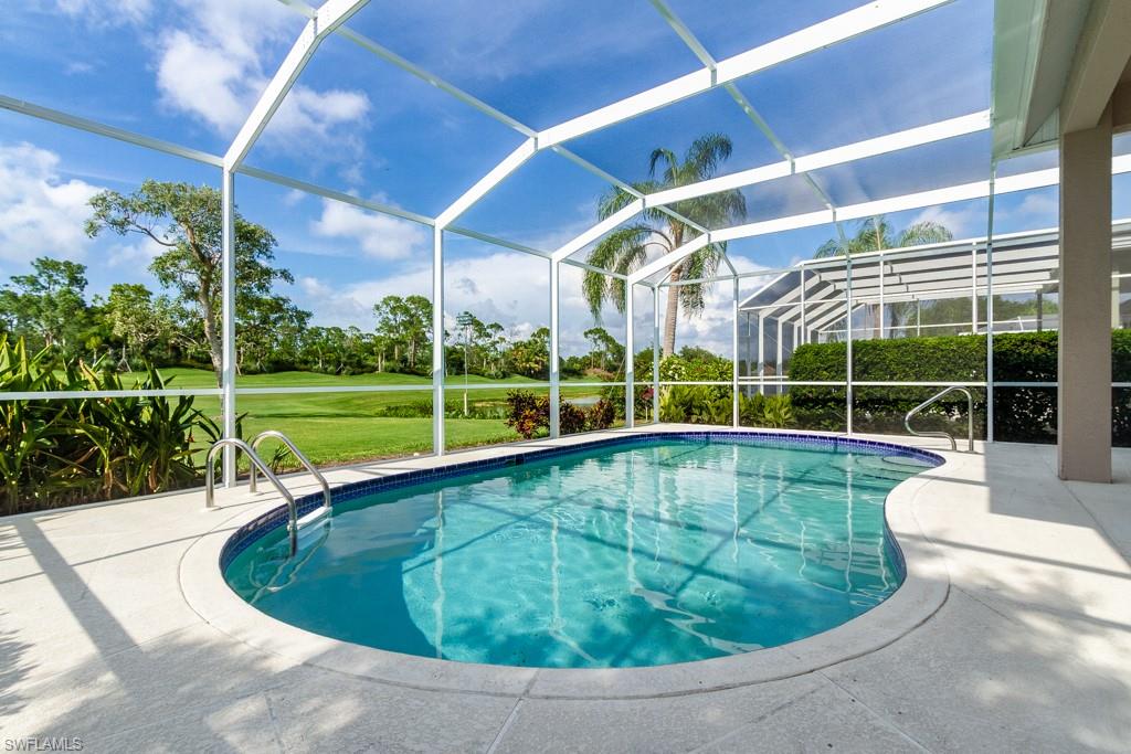 1869 Pondside Lane Naples, FL 34109 - Photo 19 of 35 a view of a backyard with swimming pool