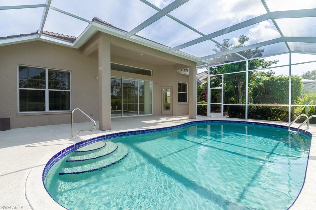 1869 Pondside Lane Naples, FL 34109 - Photo 20 of 35 a view of a house with a backyard and a porch