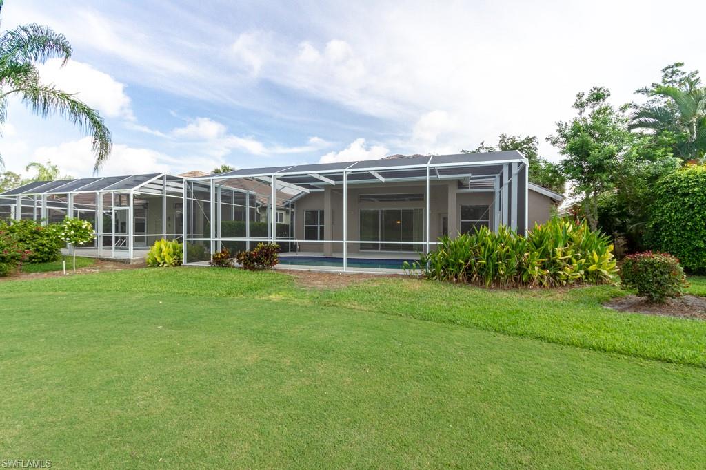 1869 Pondside Lane Naples, FL 34109 - Photo 22 of 35 a view of a house with a backyard