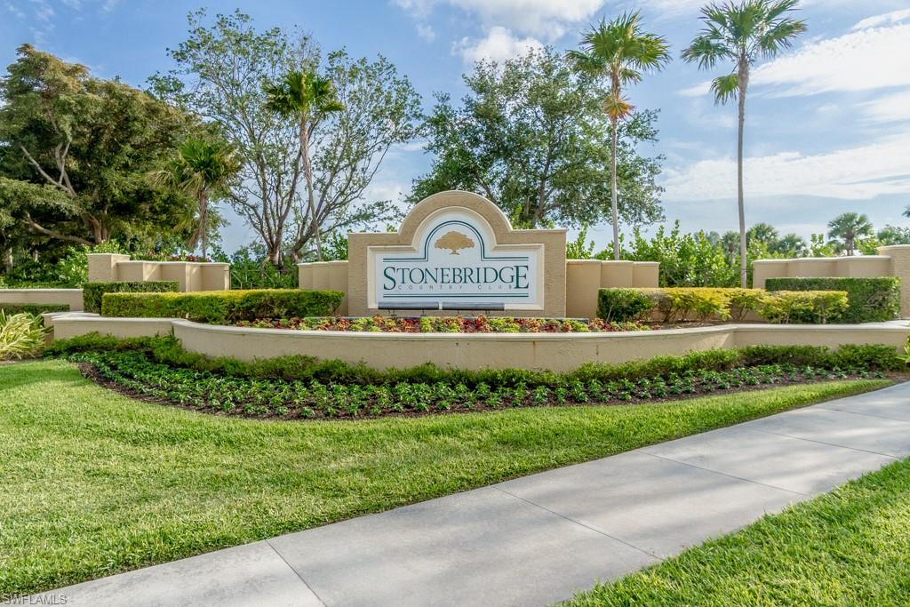 1869 Pondside Lane Naples, FL 34109 - Photo 24 of 35 a front view of a house with a yard and potted plants