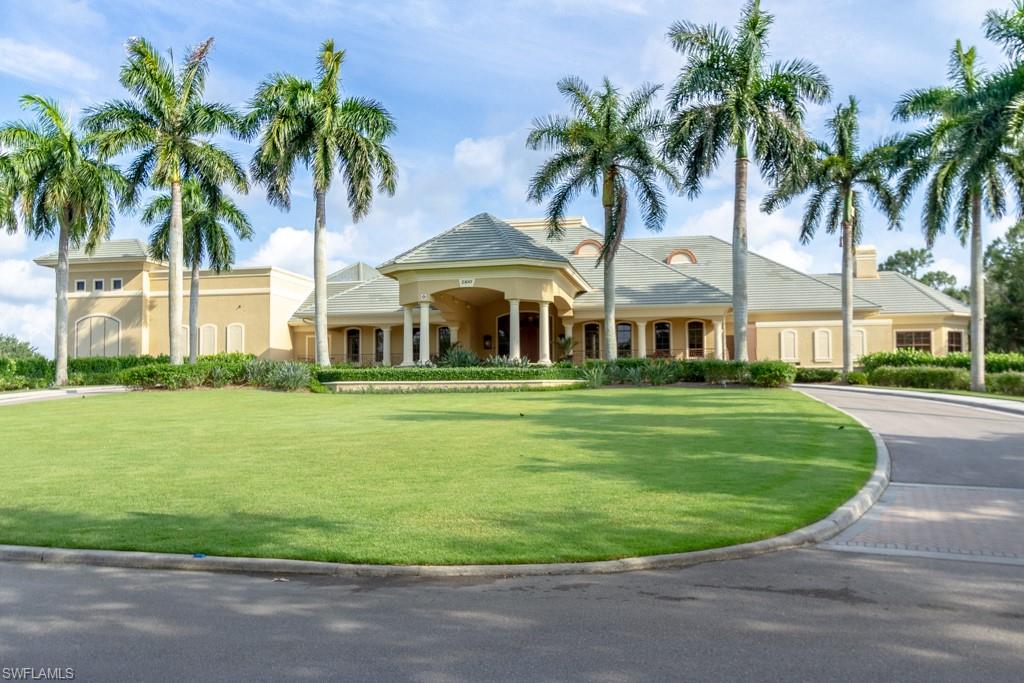 1869 Pondside Lane Naples, FL 34109 - Photo 25 of 35 a front view of a house with a garden and trees