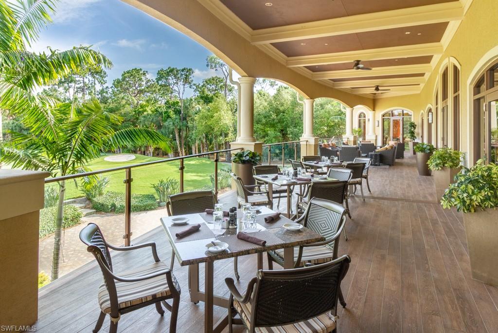 1869 Pondside Lane Naples, FL 34109 - Photo 27 of 35 a view of a patio with table and chairs and potted plants