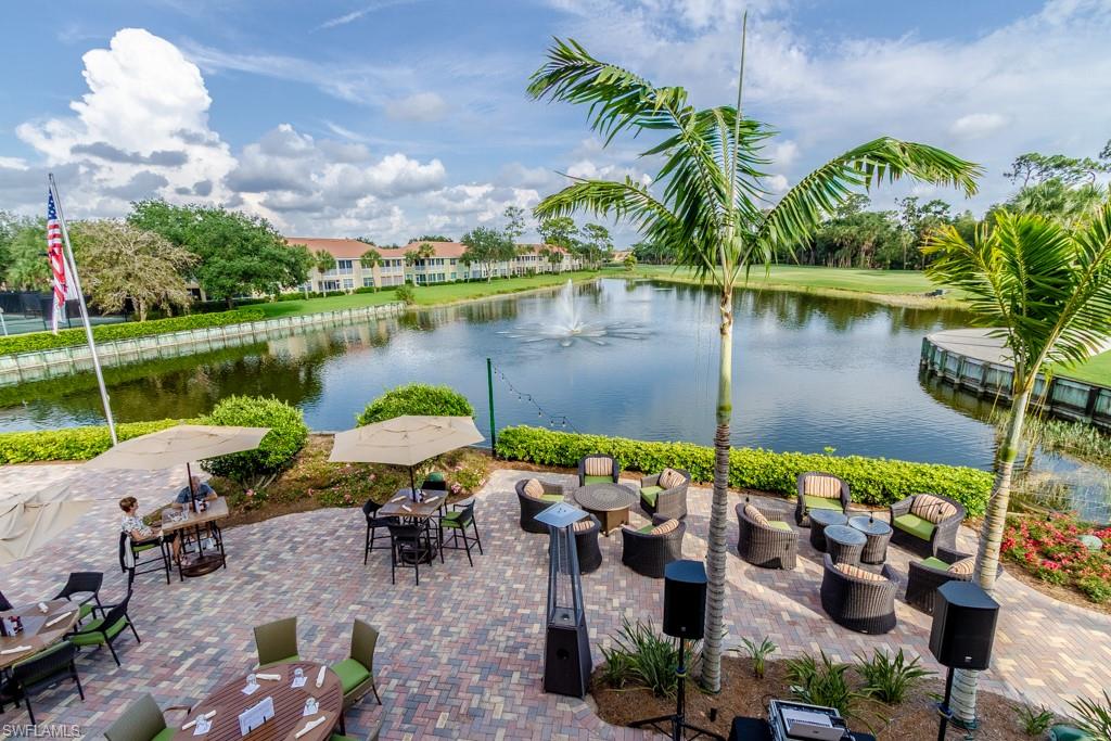 1869 Pondside Lane Naples, FL 34109 - Photo 29 of 35 an outdoor space with lounge chair and purple flowers