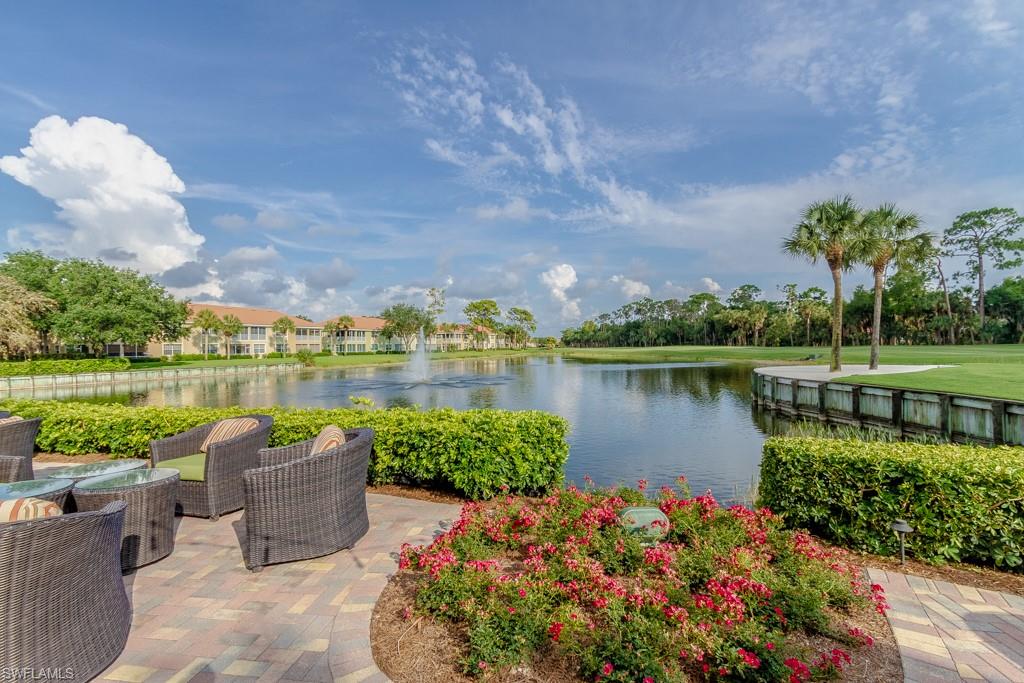 1869 Pondside Lane Naples, FL 34109 - Photo 31 of 35 a view of a lake with a garden and houses