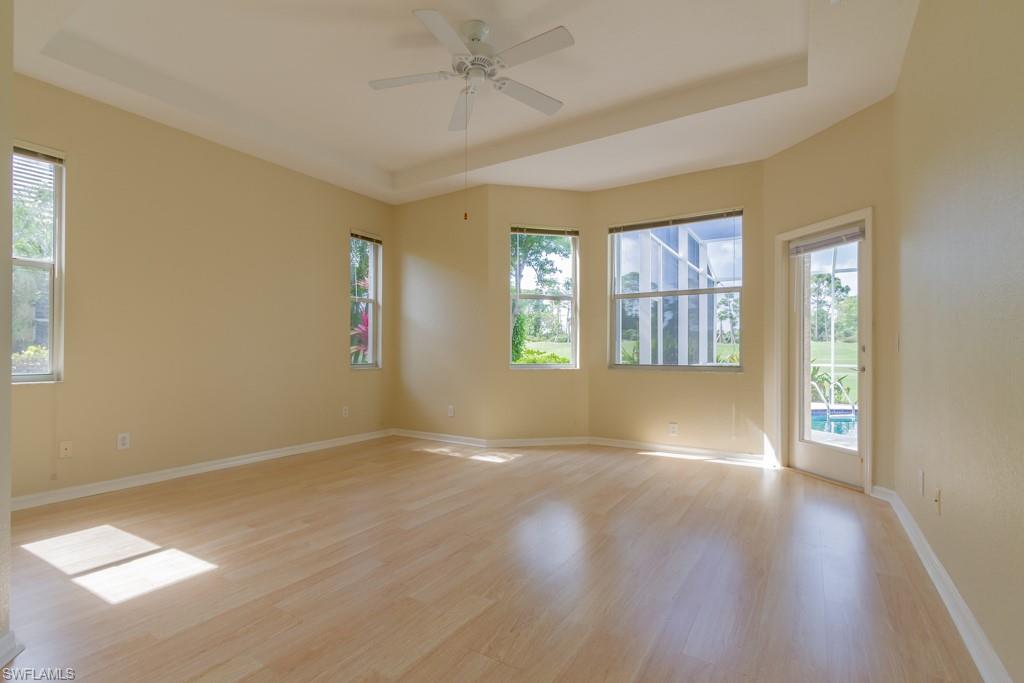 1869 Pondside Lane Naples, FL 34109 - Photo 10 of 35 a view of an empty room with a window and wooden floor