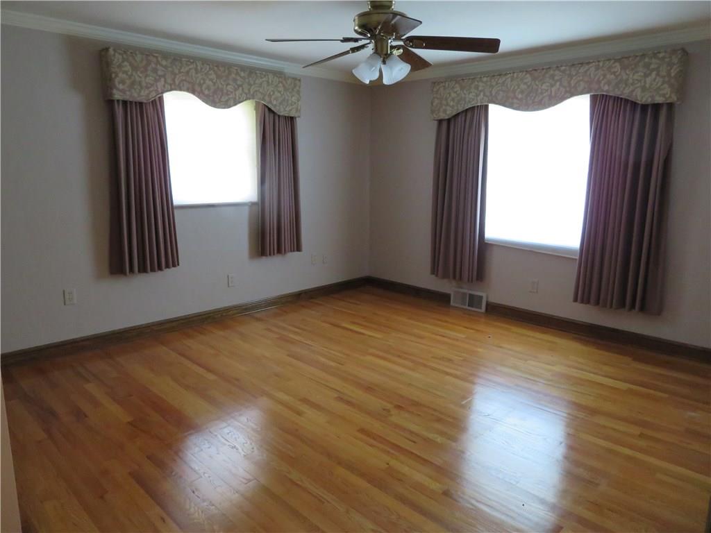 3701 Wayne Road Munhall, PA 15120 - Photo 7 of 20 Large master bedroom with gleaming hardwood flooring and crown molding, custom window treatments