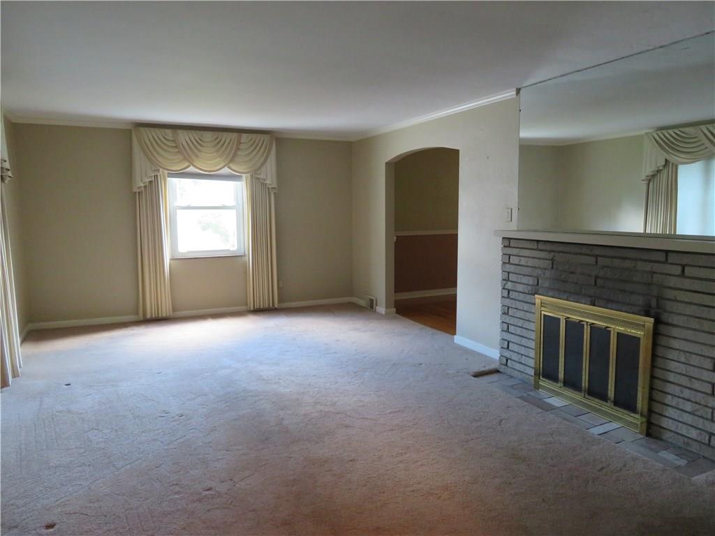 3701 Wayne Road Munhall, PA 15120 - Photo 8 of 20 Large livingroom with crown molding, gas fireplace, custom window treatments, hardwood flooring