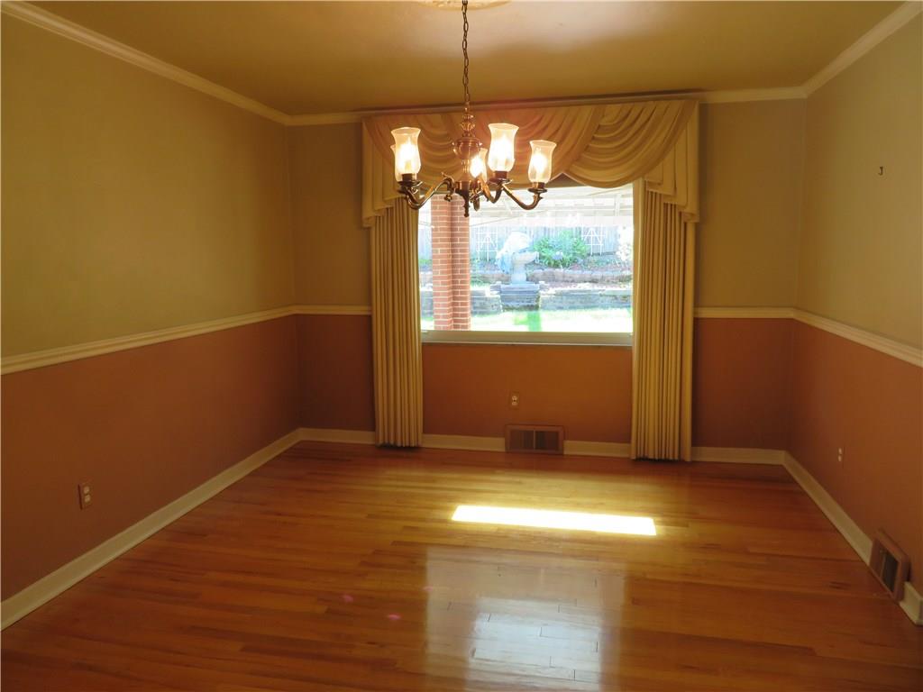3701 Wayne Road Munhall, PA 15120 - Photo 9 of 20 Gleaming hardwood flooring with chair rail and crown molding in Dining room