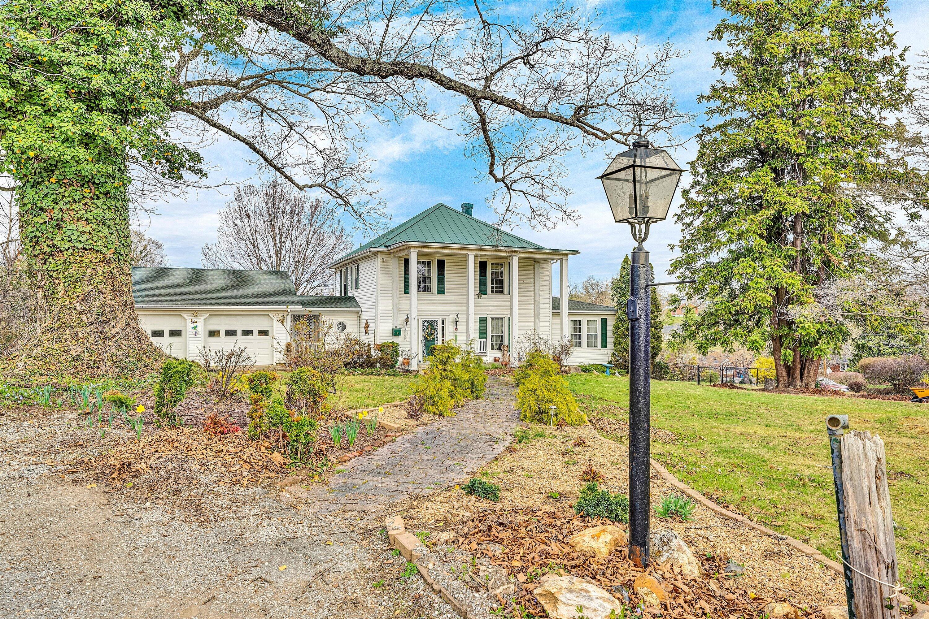 4015 Mud Lick Road Southwest Roanoke, VA 24018 - Photo 1 of 36 a front view of a house with garden