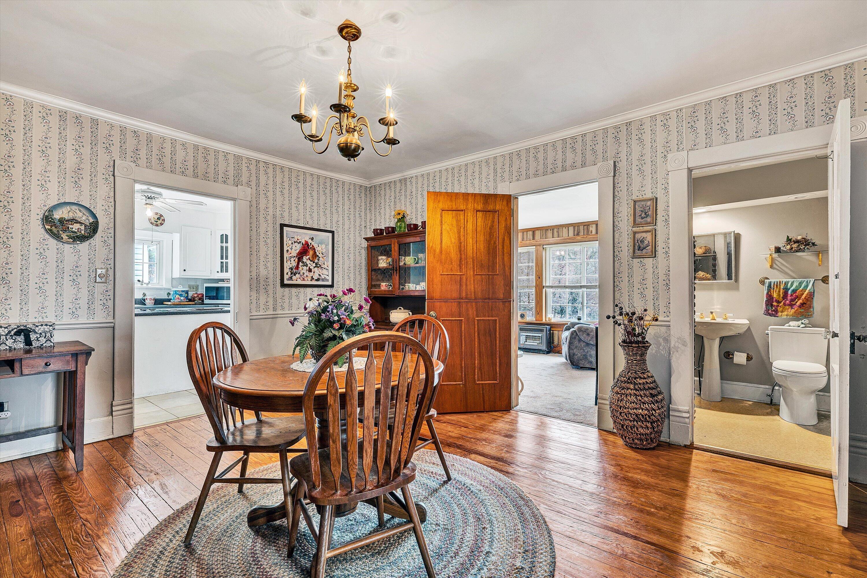 4015 Mud Lick Road Southwest Roanoke, VA 24018 - Photo 15 of 36 a view of a dining room with furniture window and wooden floor