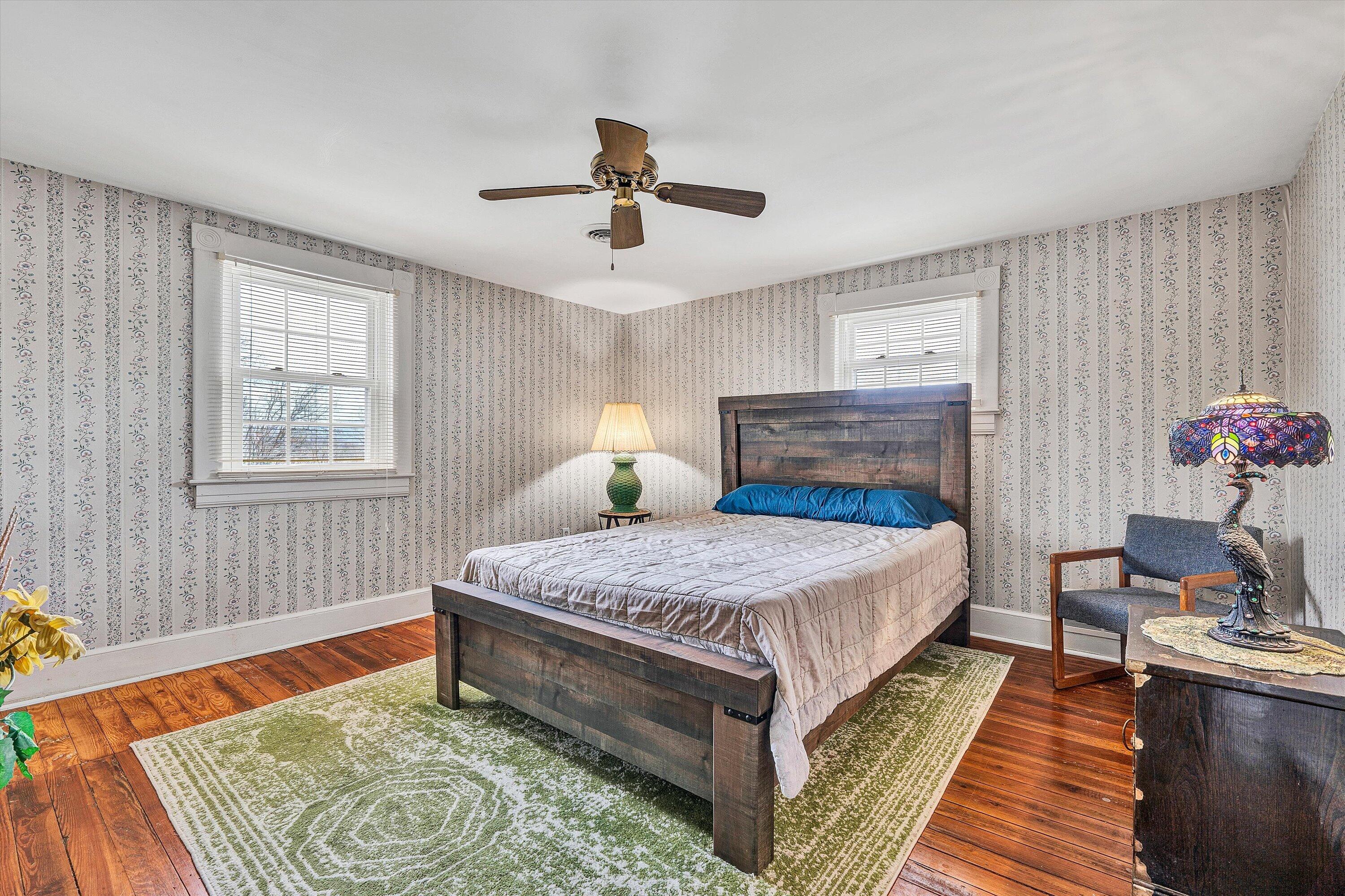 4015 Mud Lick Road Southwest Roanoke, VA 24018 - Photo 27 of 36 a bedroom with a bed and wooden floor