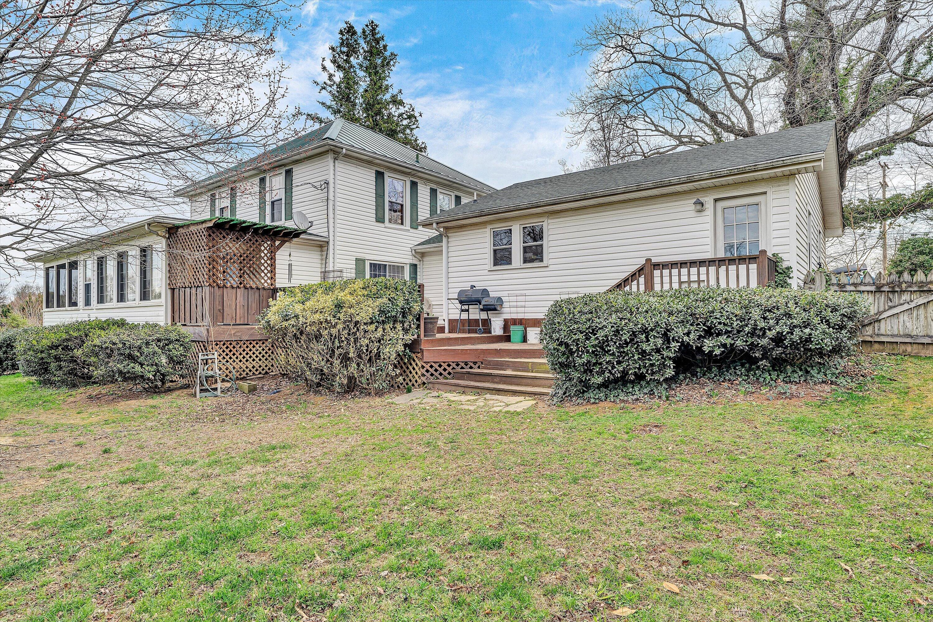 4015 Mud Lick Road Southwest Roanoke, VA 24018 - Photo 32 of 36 a white house that has a small yard and large trees