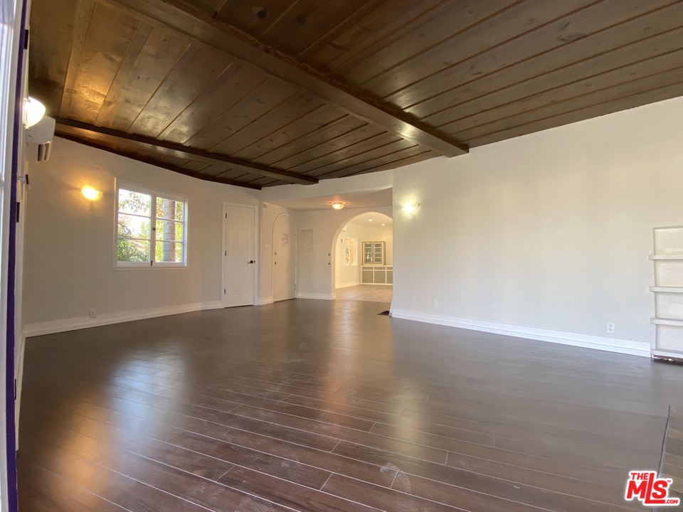 4247 9th Avenue Los Angeles, CA 90008 - Photo 16 of 45 a view of an empty room with wooden floor and a window