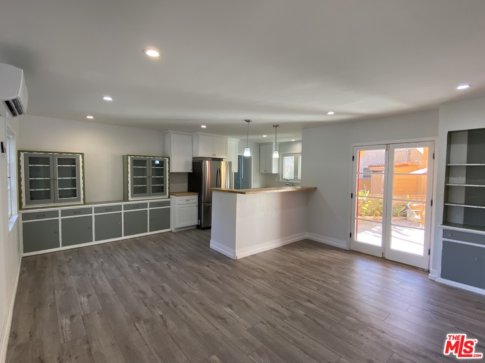 4247 9th Avenue Los Angeles, CA 90008 - Photo 19 of 45 an empty room with wooden floor and windows