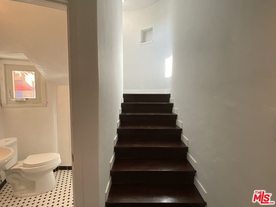 4247 9th Avenue Los Angeles, CA 90008 - Photo 25 of 45 a bathroom with a toilet and a shower curtain