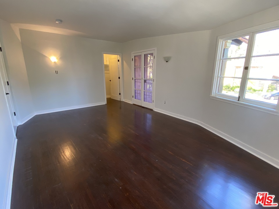 4247 9th Avenue Los Angeles, CA 90008 - Photo 28 of 45 an empty room with wooden floor and windows
