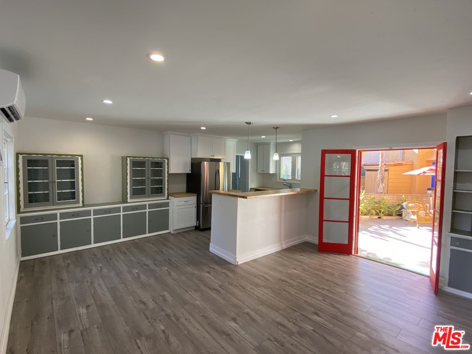 4247 9th Avenue Los Angeles, CA 90008 - Photo 3 of 45 a view of an empty room with wooden floor and a window