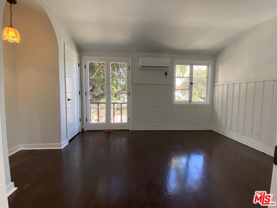 4247 9th Avenue Los Angeles, CA 90008 - Photo 31 of 45 an empty room with wooden floor and windows