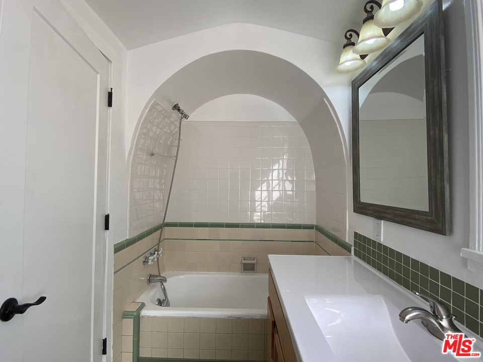 4247 9th Avenue Los Angeles, CA 90008 - Photo 39 of 45 a bathroom with a bathtub and a shower