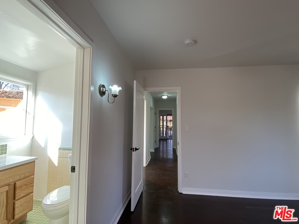 4247 9th Avenue Los Angeles, CA 90008 - Photo 40 of 45 a view of a hallway with wooden floor and a bathroom