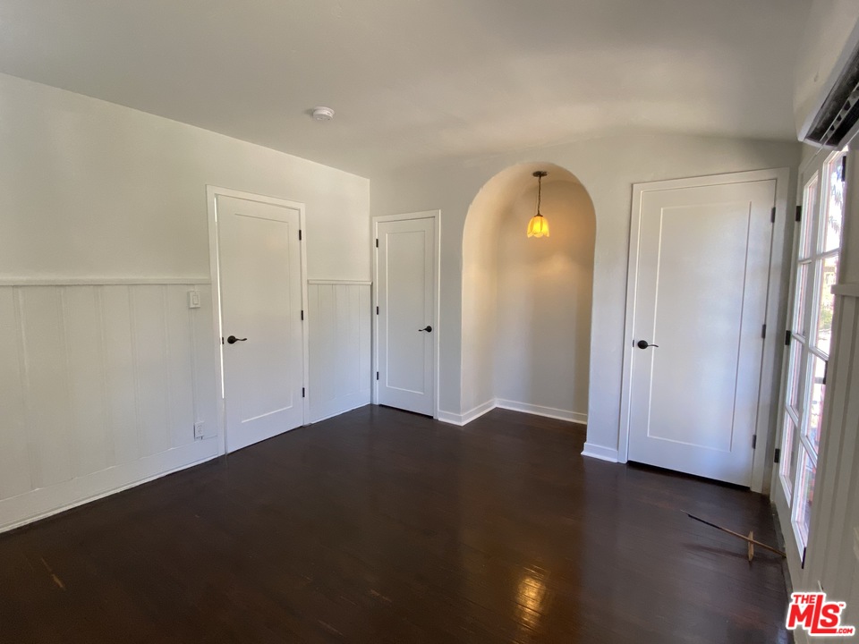 4247 9th Avenue Los Angeles, CA 90008 - Photo 7 of 45 an empty room with wooden floor and windows
