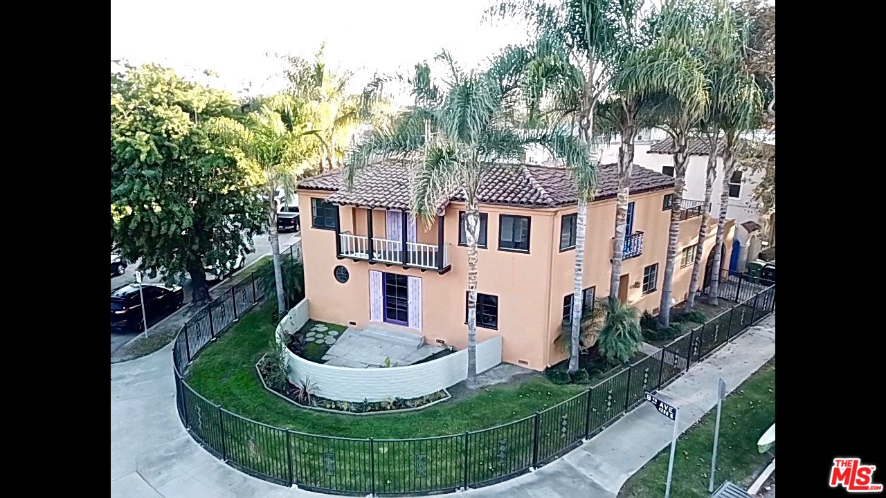 4247 9th Avenue Los Angeles, CA 90008 - Photo 9 of 45 a view of a white house with a big yard and potted plants