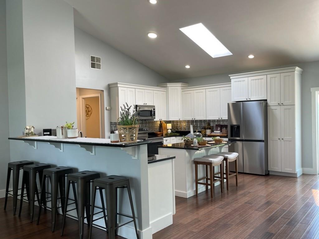 2149 Kingview Road Scottdale, PA 15683 - Photo 7 of 31 a kitchen with a table chairs refrigerator and cabinets