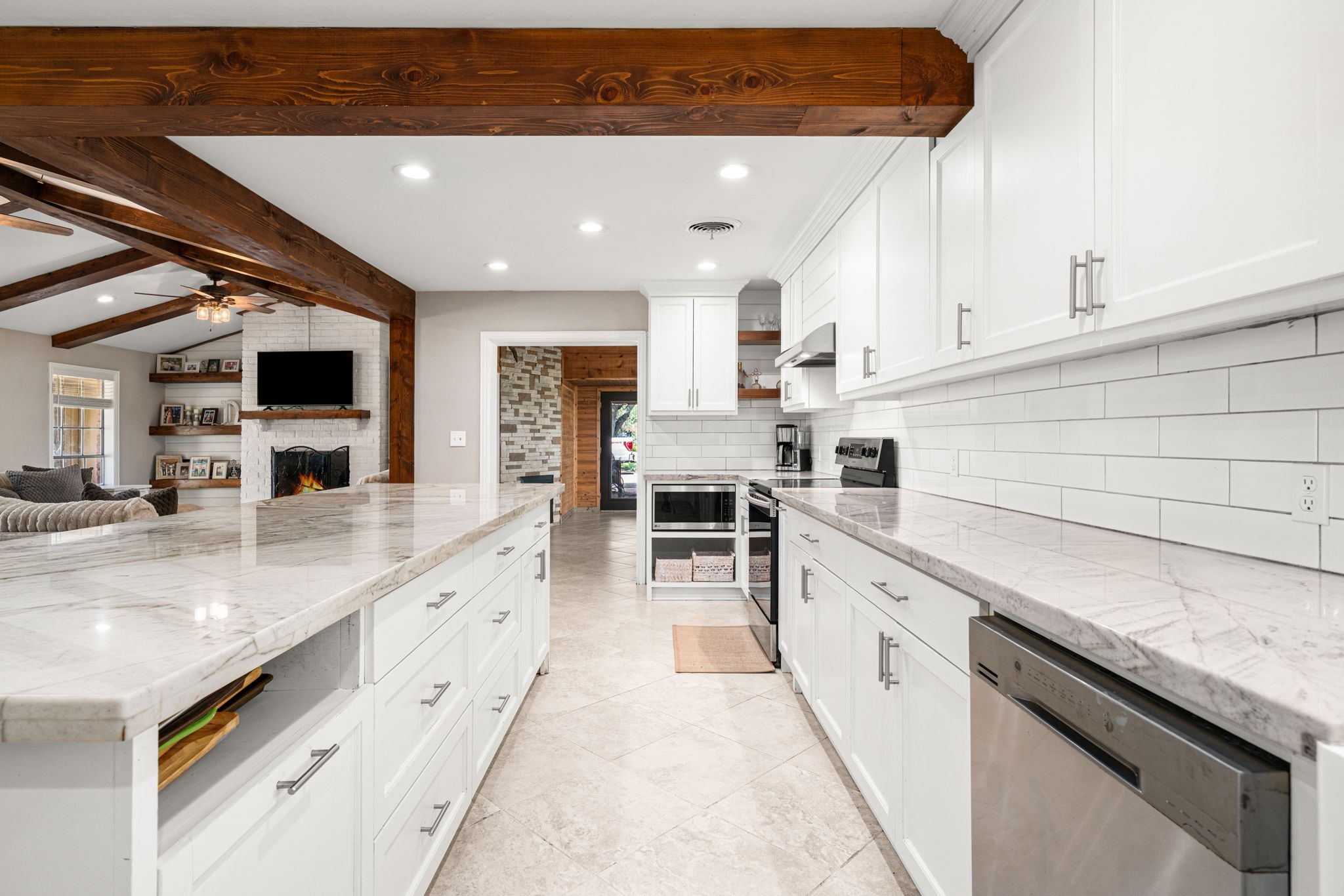 3148 FM 333 Road Garwood, TX 77442 - Photo 16 of 50 a large white kitchen with stainless steel appliances granite countertop a stove and a sink