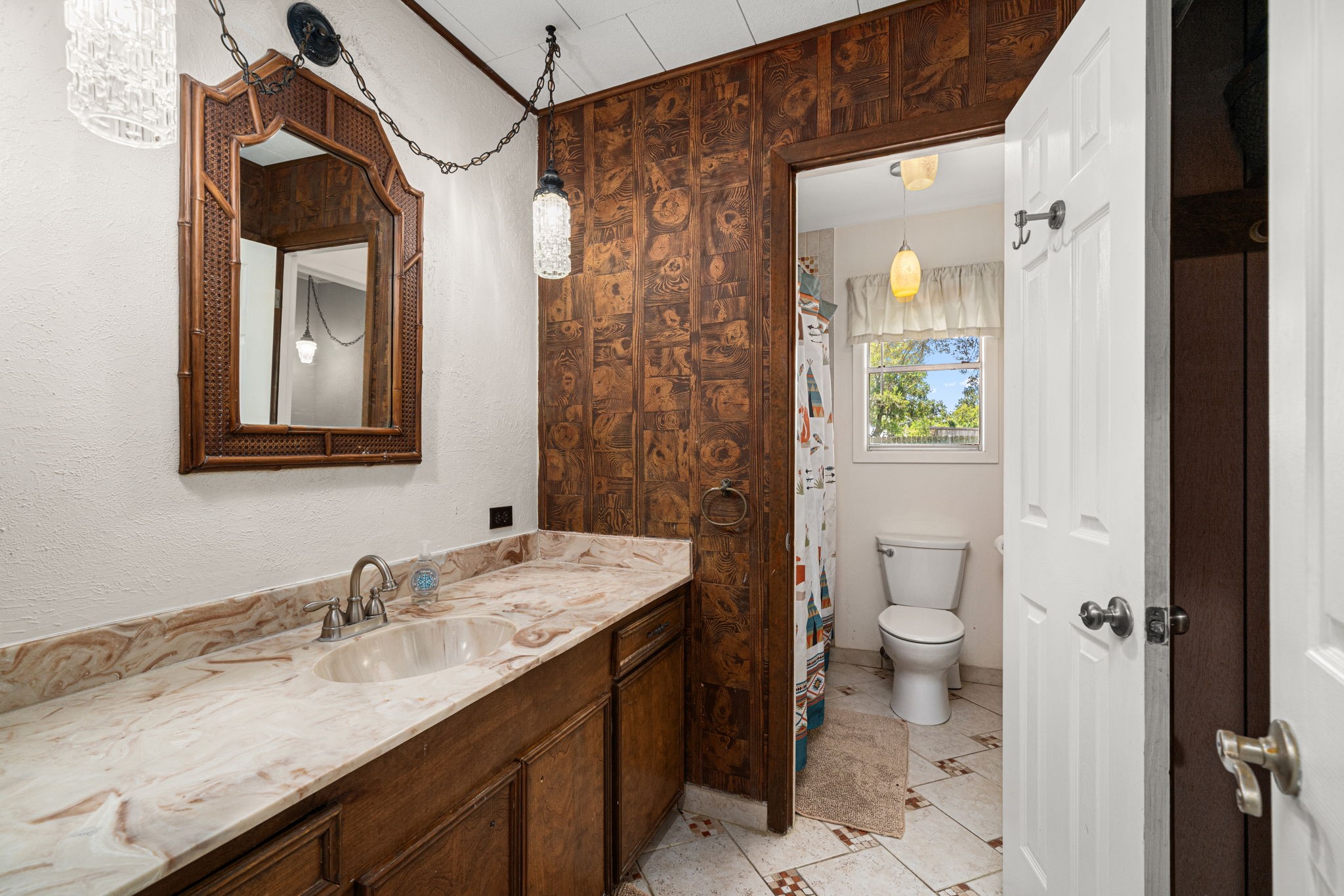 3148 FM 333 Road Garwood, TX 77442 - Photo 27 of 50 a bathroom with a granite countertop sink a toilet and shower