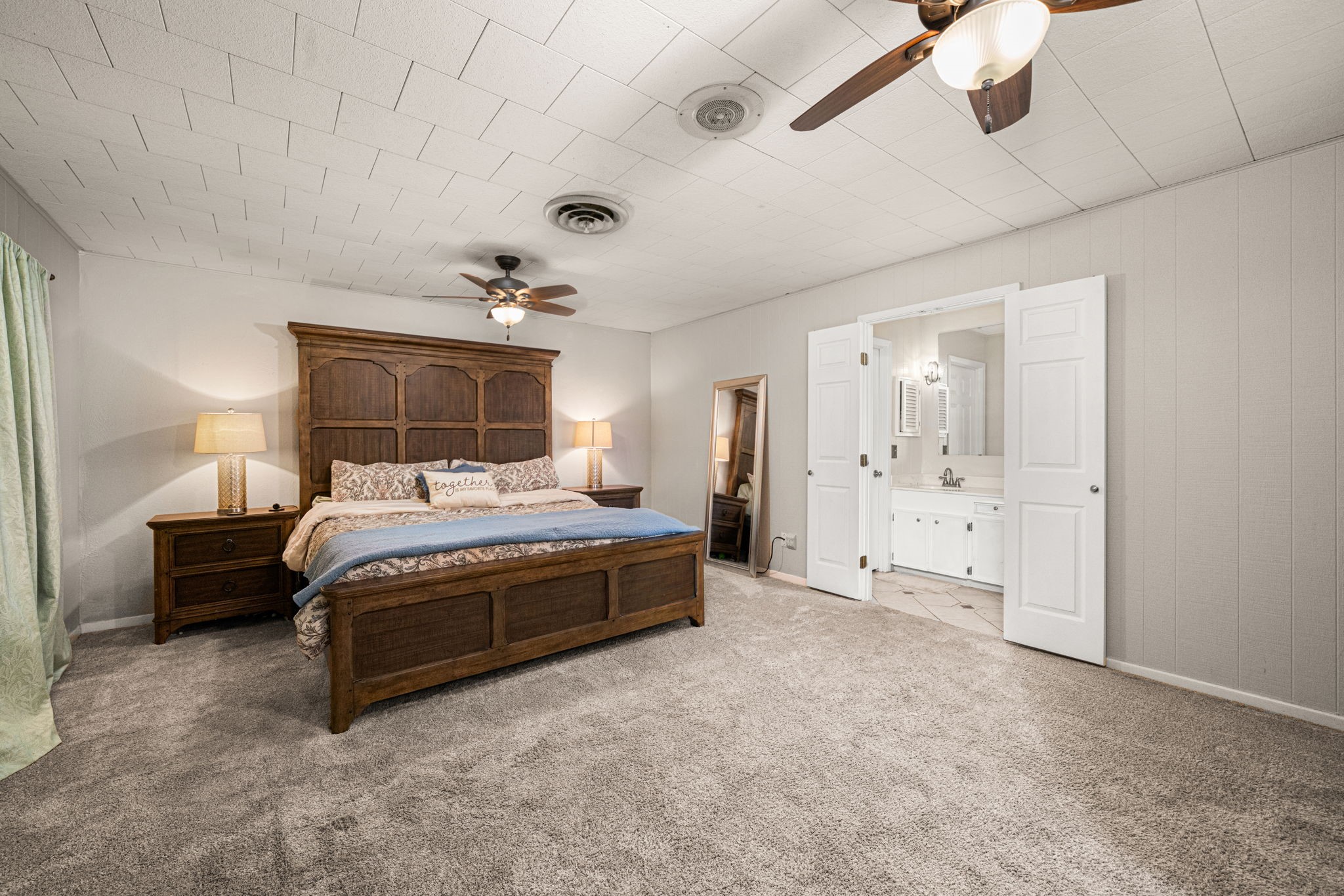 3148 FM 333 Road Garwood, TX 77442 - Photo 28 of 50 a spacious bedroom with a bed and a chandelier