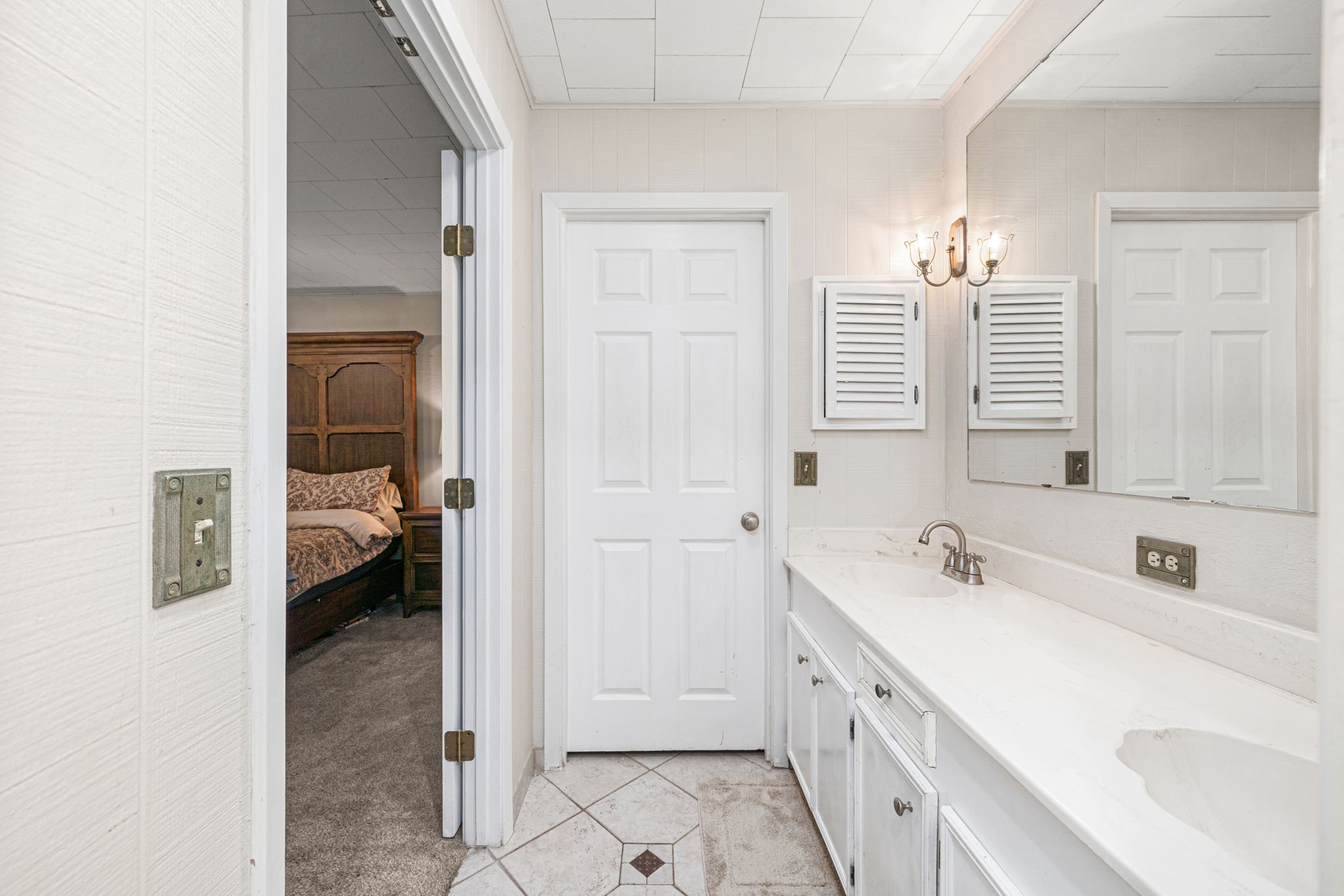 3148 FM 333 Road Garwood, TX 77442 - Photo 31 of 50 a bathroom with a double vanity sink a mirror and a bathtub