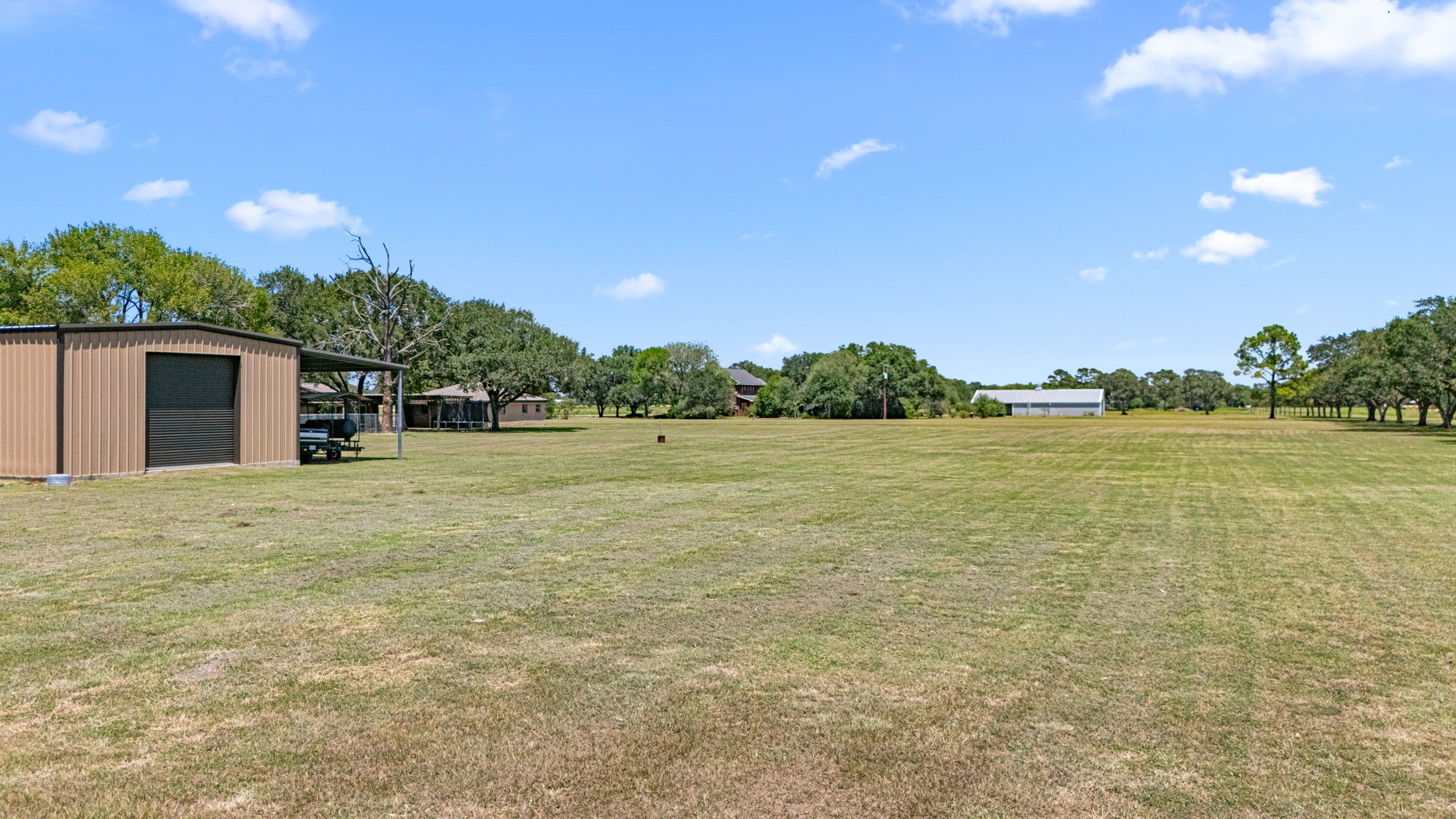 3148 FM 333 Road Garwood, TX 77442 - Photo 41 of 50 a backyard of a house with lots of green space and outdoor space
