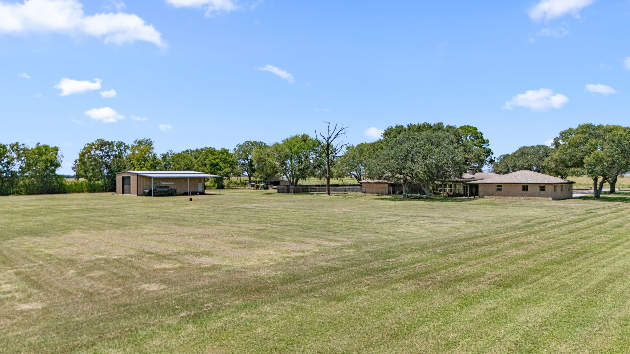 3148 FM 333 Road Garwood, TX 77442 - Photo 47 of 50 a front view of a house with a yard and trees