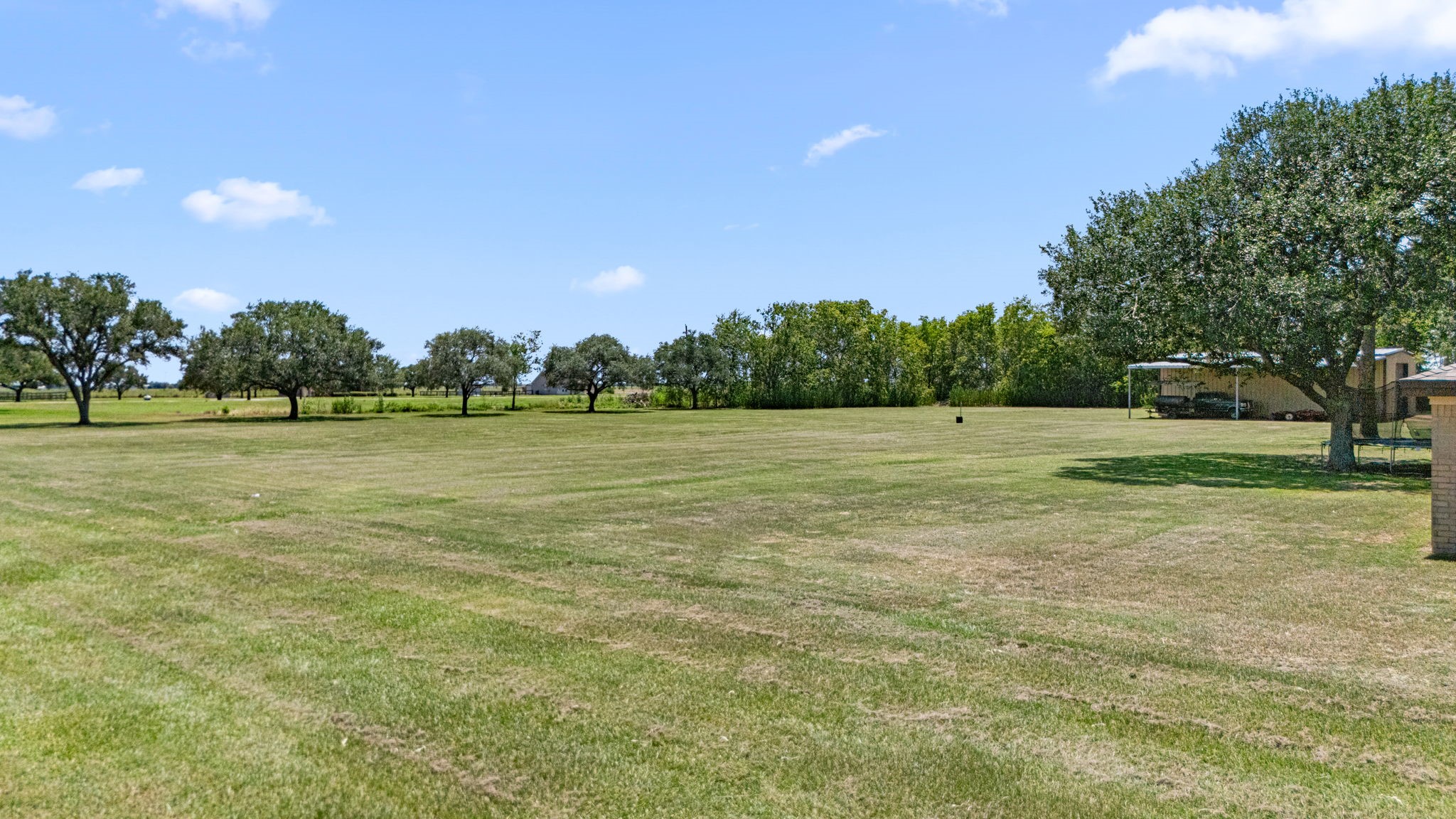 3148 FM 333 Road Garwood, TX 77442 - Photo 48 of 50 a view of a field with trees in the background