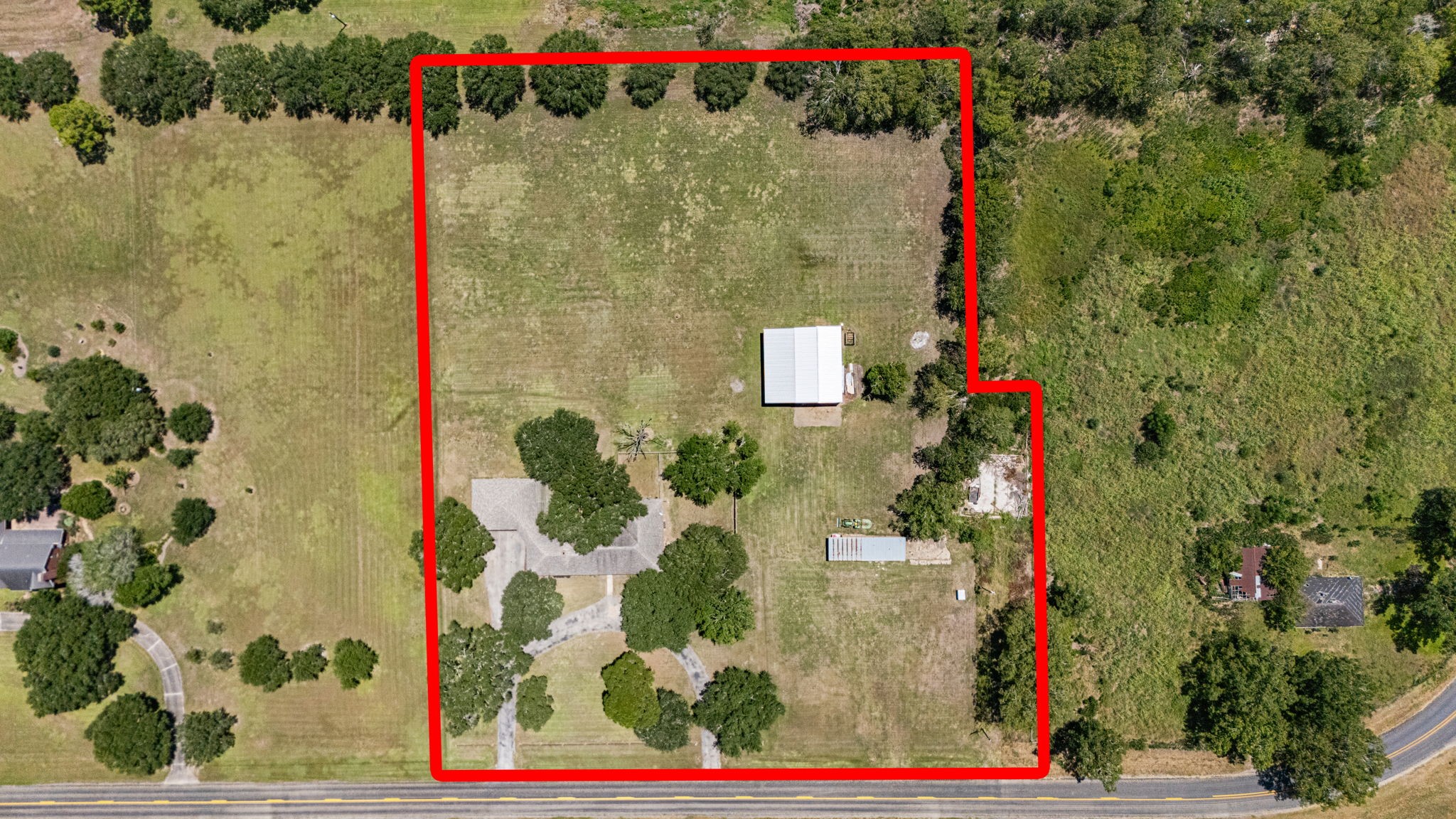 3148 FM 333 Road Garwood, TX 77442 - Photo 50 of 50 a small white building sitting next to a white house