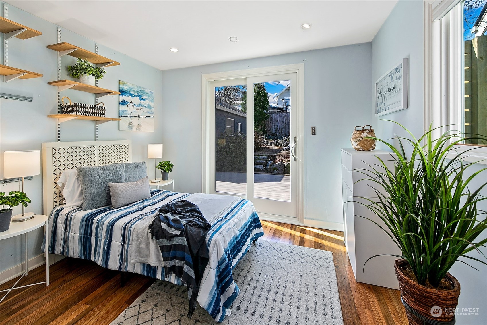 4415 Eastern Avenue North Seattle, WA 98103 - Photo 14 of 27 a bedroom with a bed table flowerpot and window