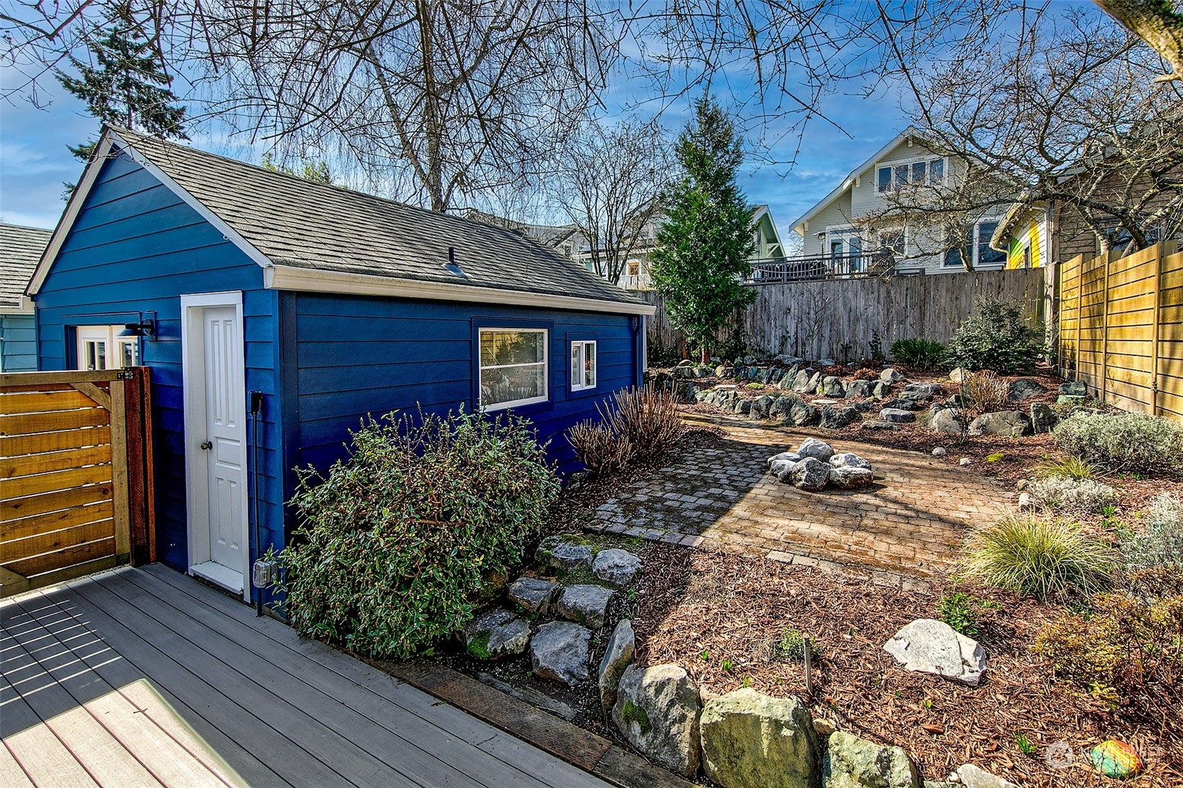 4415 Eastern Avenue North Seattle, WA 98103 - Photo 21 of 27 a front view of house with garden and trees in the background