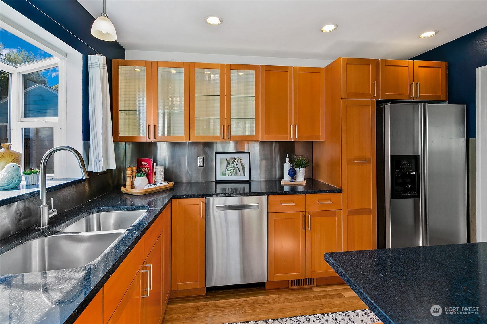 4415 Eastern Avenue North Seattle, WA 98103 - Photo 9 of 27 a kitchen with stainless steel appliances granite countertop a sink a stove and a refrigerator