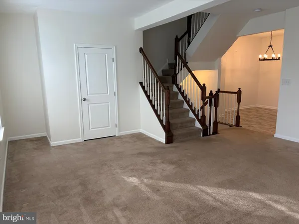 a view of an empty room with stairs