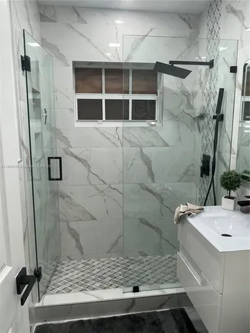a bathroom with a sink and a shower