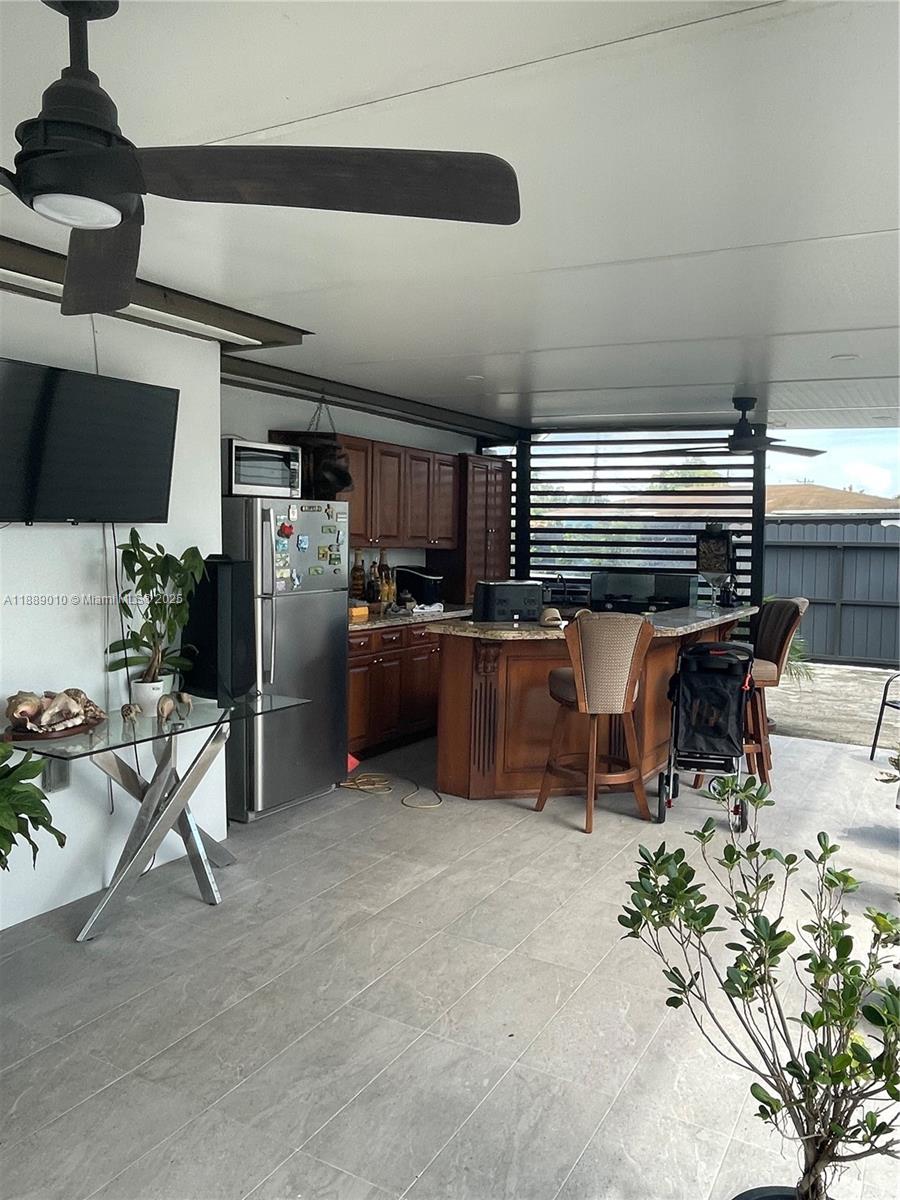 390 East 53rd Street Hialeah, FL 33013 - Photo 17 of 21 a room with furniture and a flat screen tv