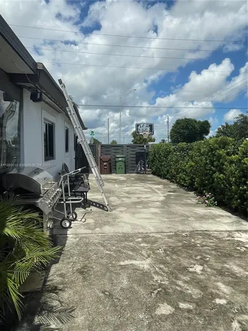 a view of a backyard with sitting area